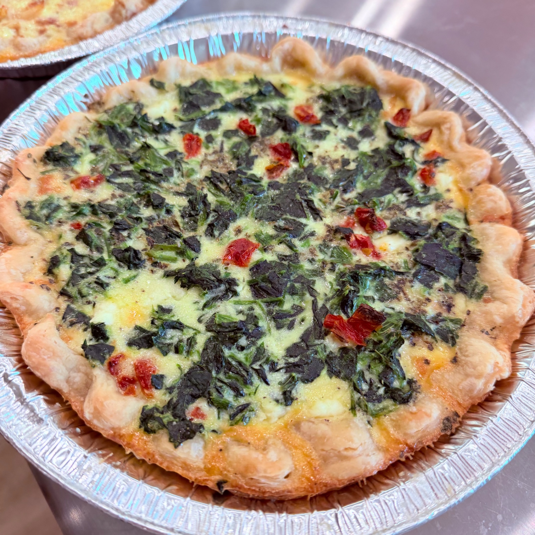 Spinach, feta and sun-dried tomato quiche in a flaky all-butter crust — sold frozen by Mama Rozi's Bakehouse in LaGrange, KY