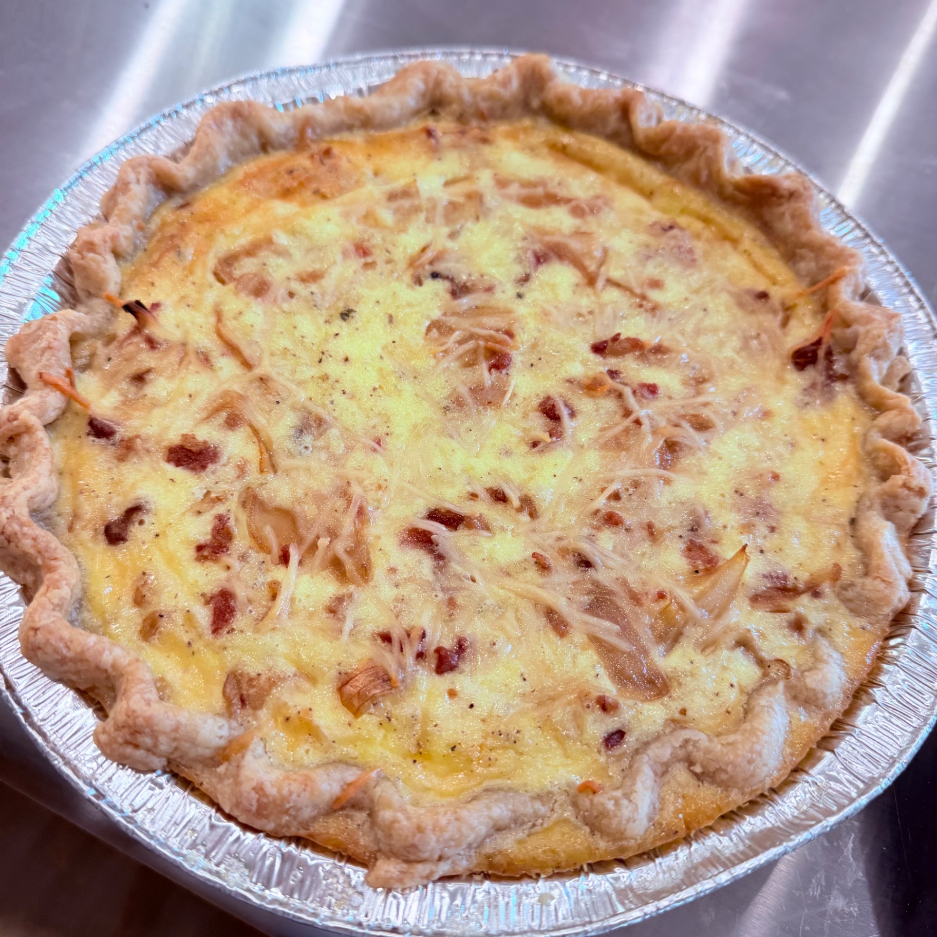 Bacon, caramelized onion and parmesan quiche in a flaky all-butter crust — sold frozen by Mama Rozi's Bakehouse in LaGrange, KY