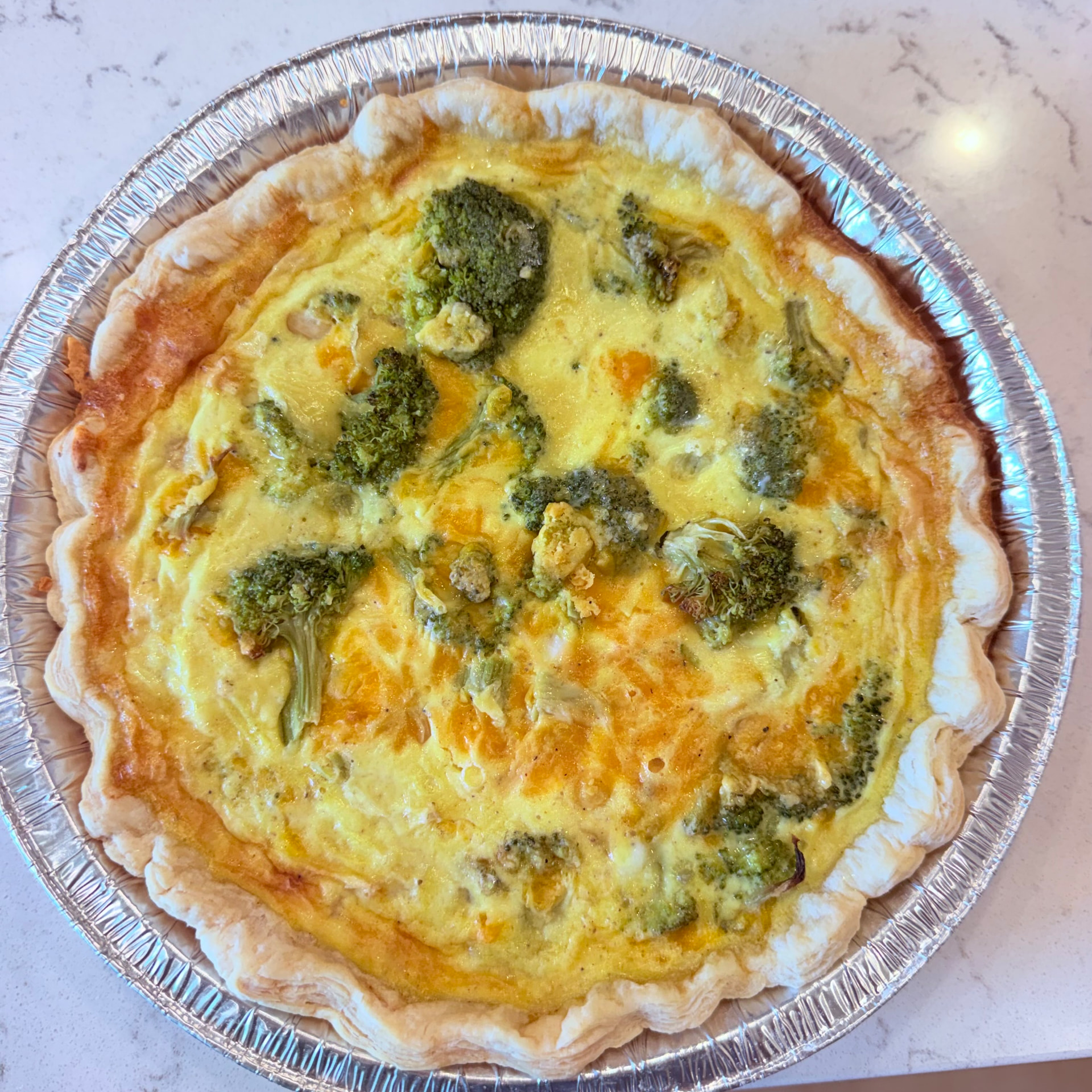 Broccoli cheddar quiche in a flaky all-butter crust — sold frozen by Mama Rozi's Bakehouse in LaGrange, KY